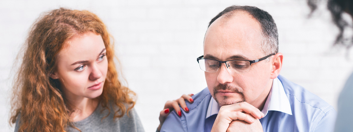  Supportive wife comforting husband with TRD during a meeting with a counselor in Fair Lawn.